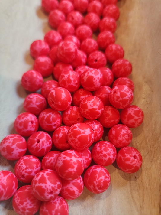 Red cowprint on pink beads custom printed 15mm silicone beads