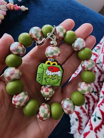 Green guy and pink elf silicone wristlet keys